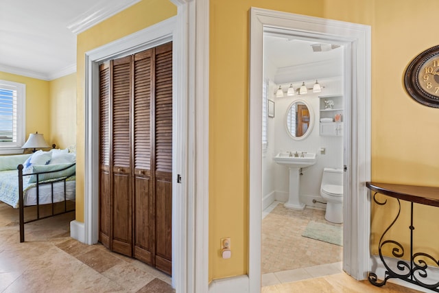 bathroom featuring crown molding, sink, toilet, and tile patterned flooring