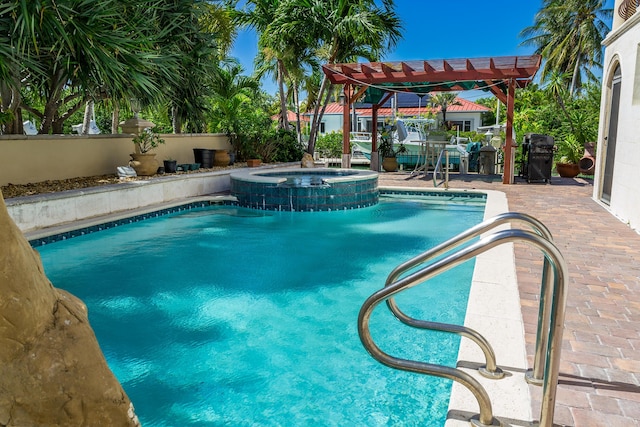 view of pool featuring an in ground hot tub, a patio area, and a pergola