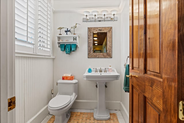 bathroom with toilet and tile patterned flooring