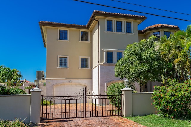 mediterranean / spanish-style home with a garage