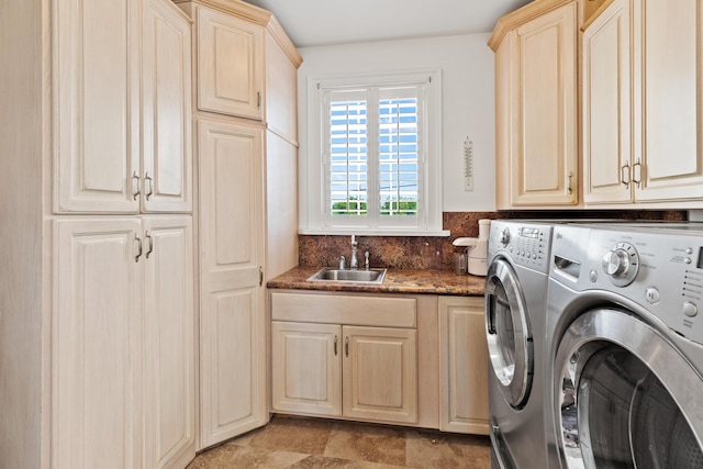 laundry room featuring cabinets, sink, and independent washer and dryer