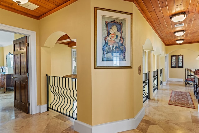 hallway with crown molding and wood ceiling