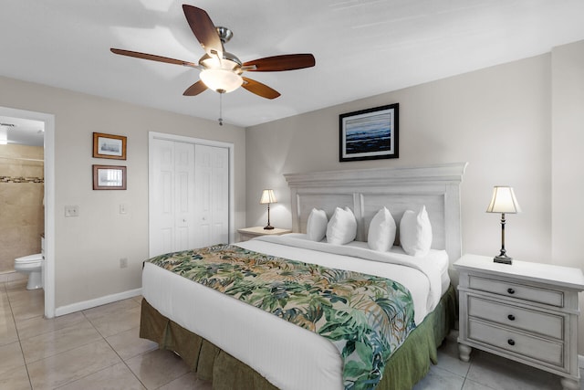 tiled bedroom with connected bathroom, ceiling fan, and a closet