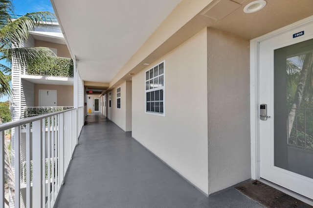 view of exterior entry featuring a balcony