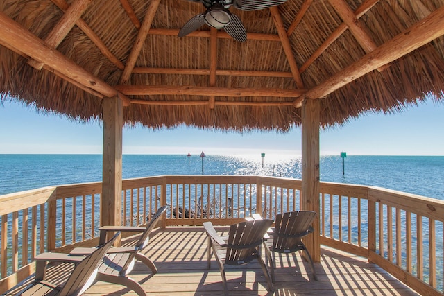 wooden deck featuring a gazebo, a water view, and ceiling fan