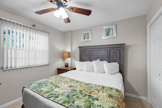 tiled bedroom with ceiling fan