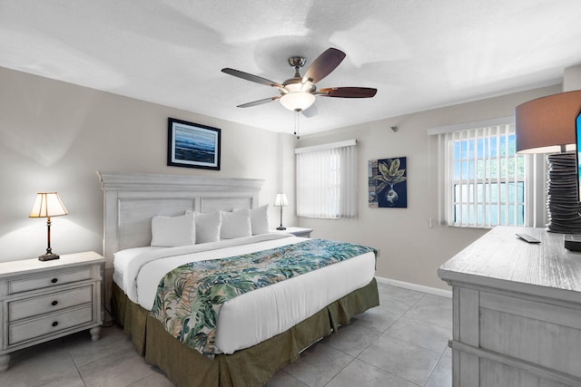 tiled bedroom featuring ceiling fan