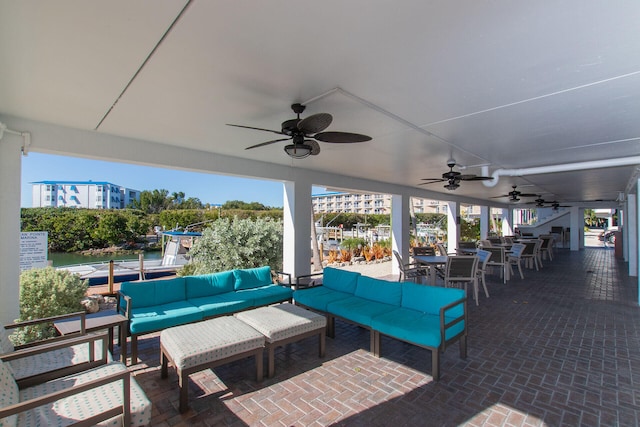 view of patio / terrace featuring an outdoor living space, an outdoor bar, and ceiling fan