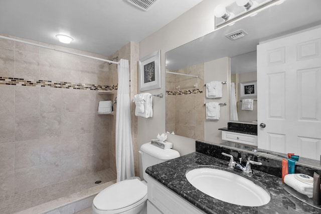 bathroom with a shower with curtain, vanity, and toilet