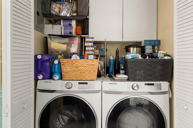 washroom with cabinet space and washing machine and dryer