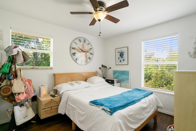 bedroom with dark wood-style flooring, multiple windows, and ceiling fan