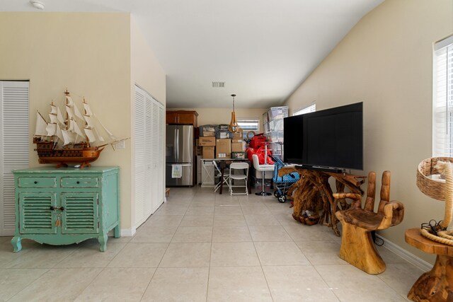 living room with baseboards, plenty of natural light, and light tile patterned floors