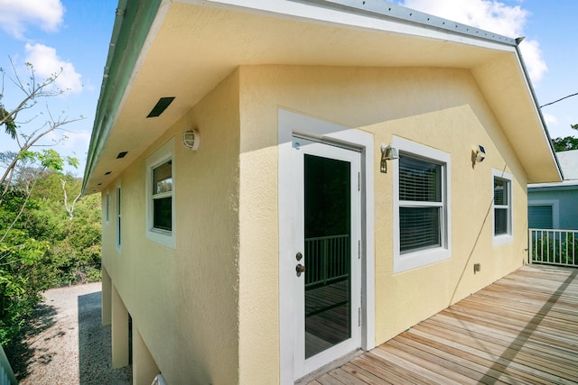 entrance to property with stucco siding