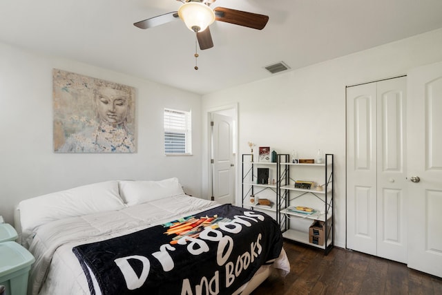 bedroom with dark wood finished floors, a closet, and a ceiling fan