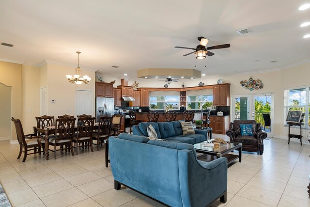 tiled living room featuring ornamental molding and ceiling fan with notable chandelier