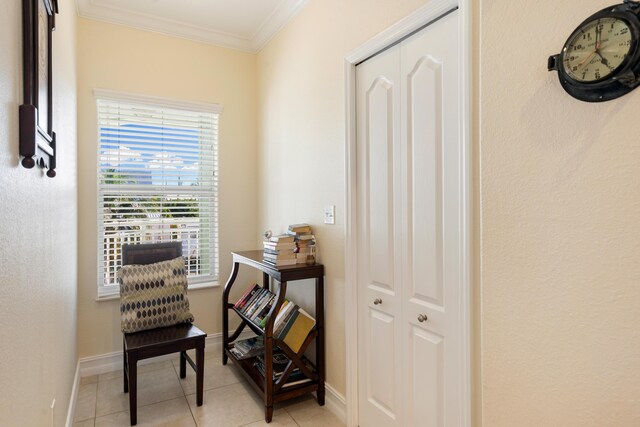 corridor featuring light tile patterned flooring and ornamental molding