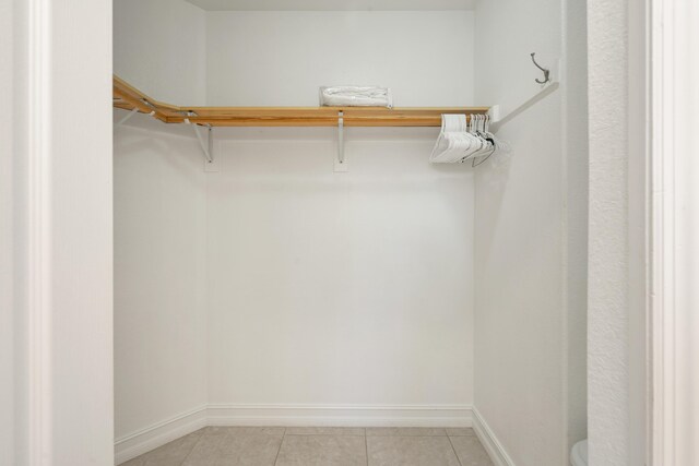 spacious closet with light tile patterned floors