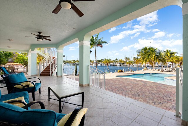 view of patio featuring ceiling fan and a water view