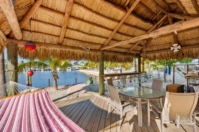 wooden deck with a water view and a gazebo