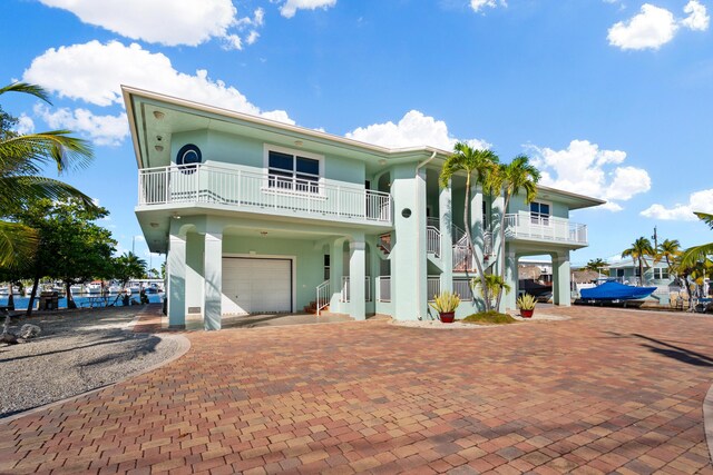 view of front of property featuring a garage and a balcony