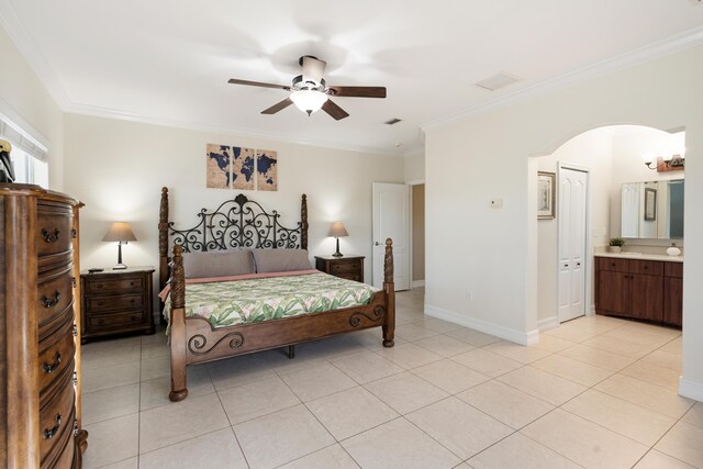 tiled bedroom featuring ensuite bathroom, ceiling fan, and crown molding