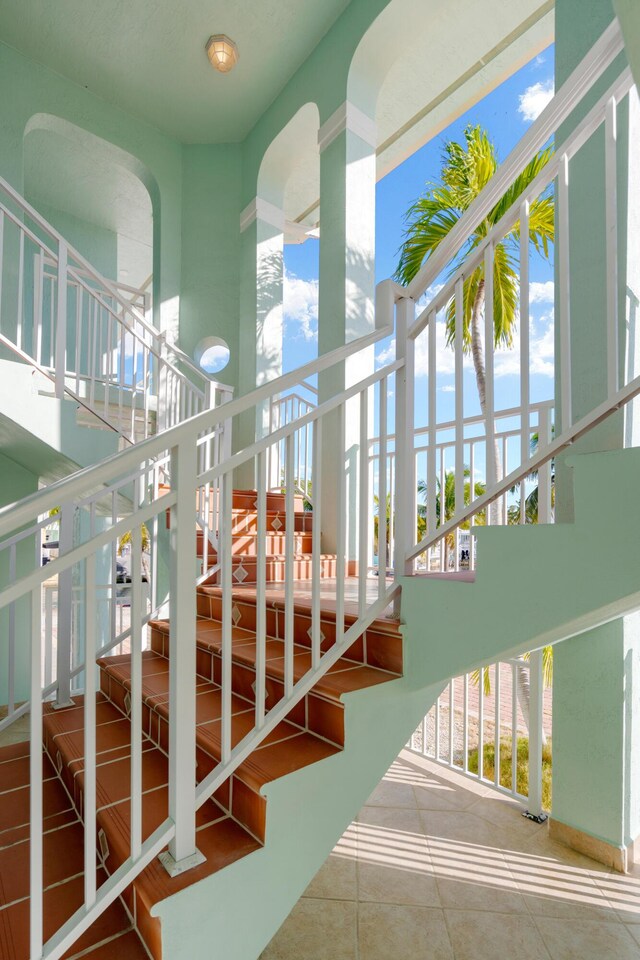 stairs featuring tile patterned floors