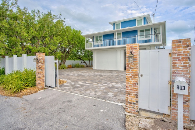 view of front of home with a garage and a balcony