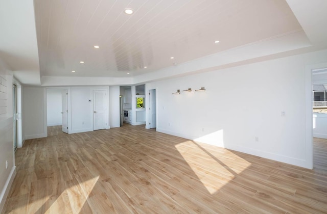 unfurnished living room featuring a raised ceiling, wooden ceiling, and light hardwood / wood-style flooring