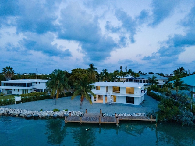 back of house featuring a balcony and a water view