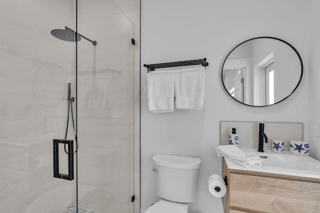 bathroom featuring an enclosed shower, vanity, and toilet