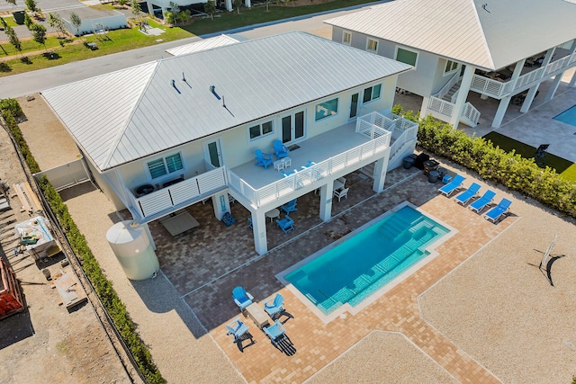 view of pool with a wooden deck and a patio area