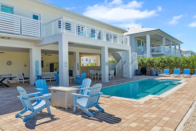 view of pool with a patio and ceiling fan