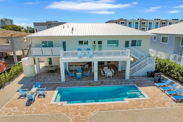 rear view of property with a balcony and a patio area