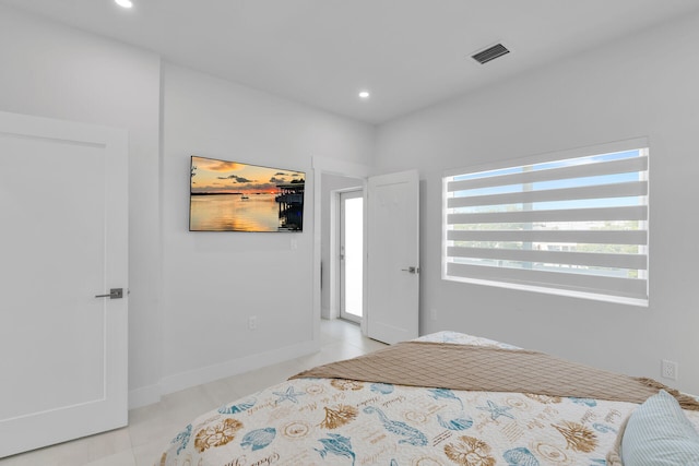 bedroom featuring light tile patterned flooring