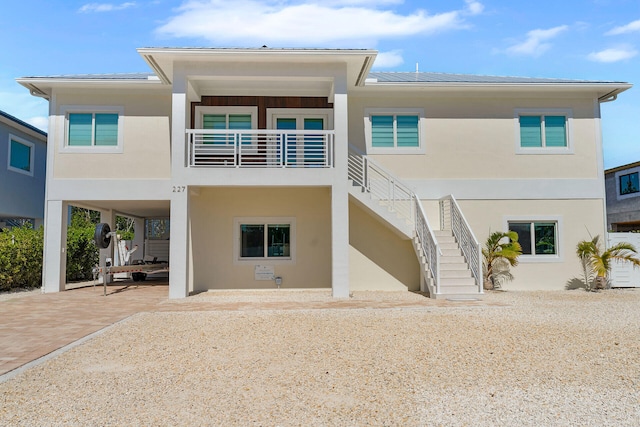 back of property with a carport