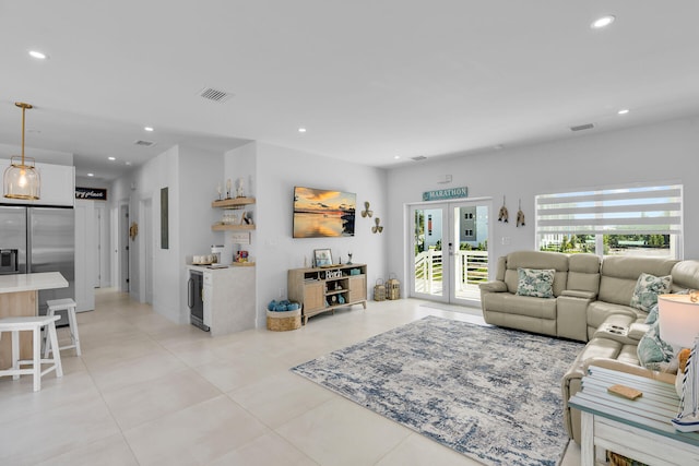 tiled living room featuring beverage cooler and french doors