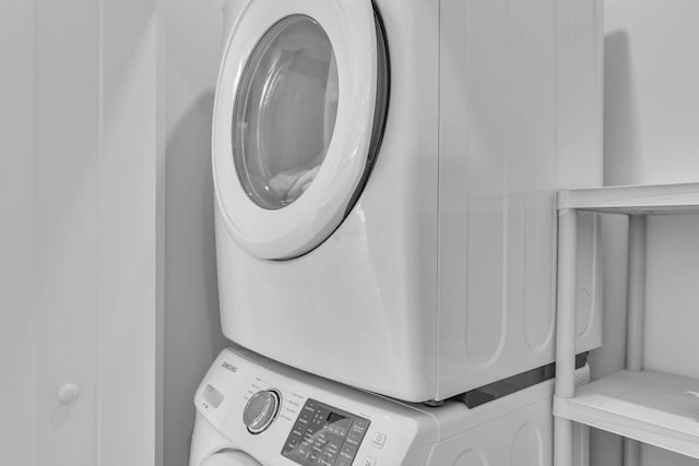 clothes washing area featuring stacked washer / drying machine