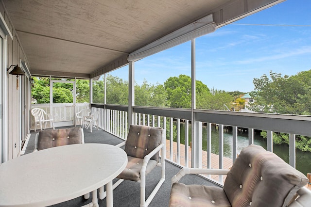 sunroom with a water view and a healthy amount of sunlight