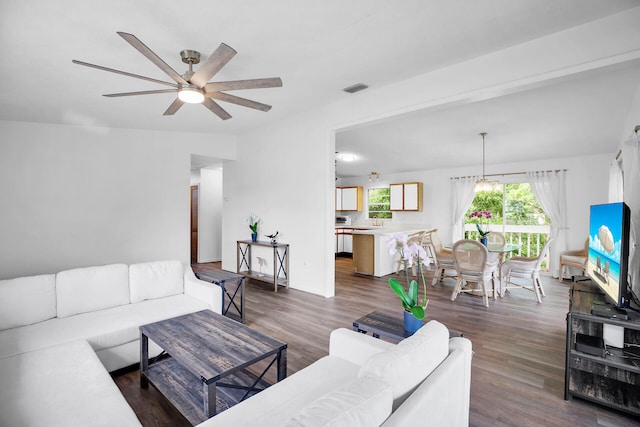 living room featuring dark hardwood / wood-style flooring and ceiling fan