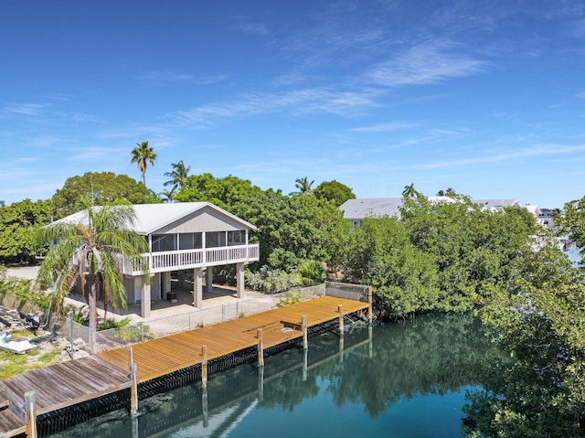 dock area featuring a patio and a water view