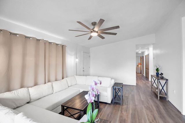 living room featuring dark hardwood / wood-style flooring and ceiling fan