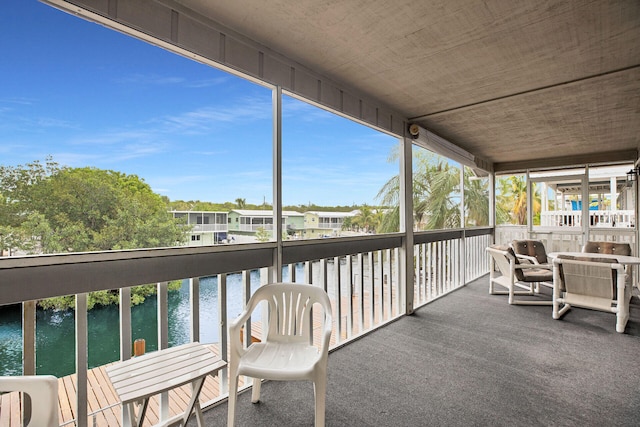 sunroom / solarium with a water view