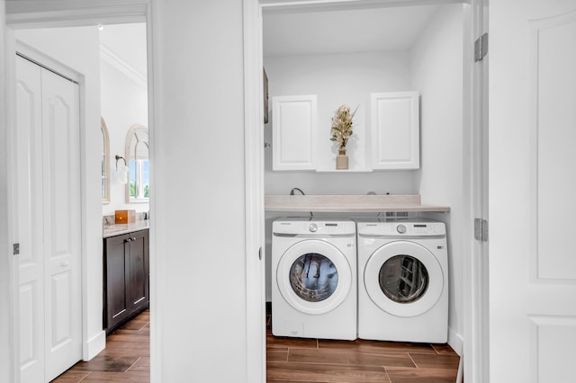 washroom with cabinets and washing machine and dryer