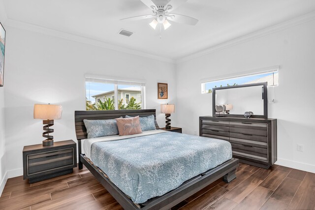 bedroom with ornamental molding and ceiling fan