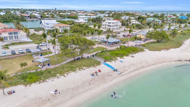 bird's eye view with a water view and a beach view