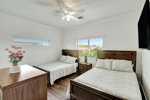 bedroom featuring multiple windows, dark wood-type flooring, ornamental molding, and ceiling fan