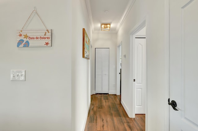 corridor with ornamental molding and dark hardwood / wood-style flooring