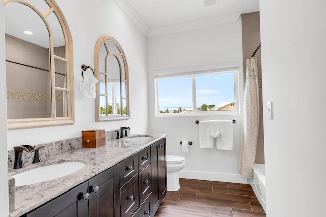 bathroom with crown molding, vanity, hardwood / wood-style flooring, and toilet