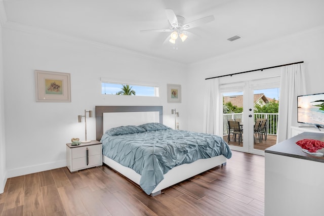 bedroom featuring access to outside, ornamental molding, dark hardwood / wood-style floors, and french doors