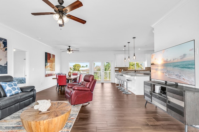living room with crown molding, sink, ceiling fan, and dark hardwood / wood-style flooring